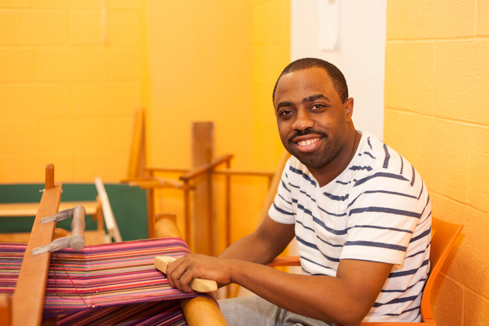 Adult program participant weaving