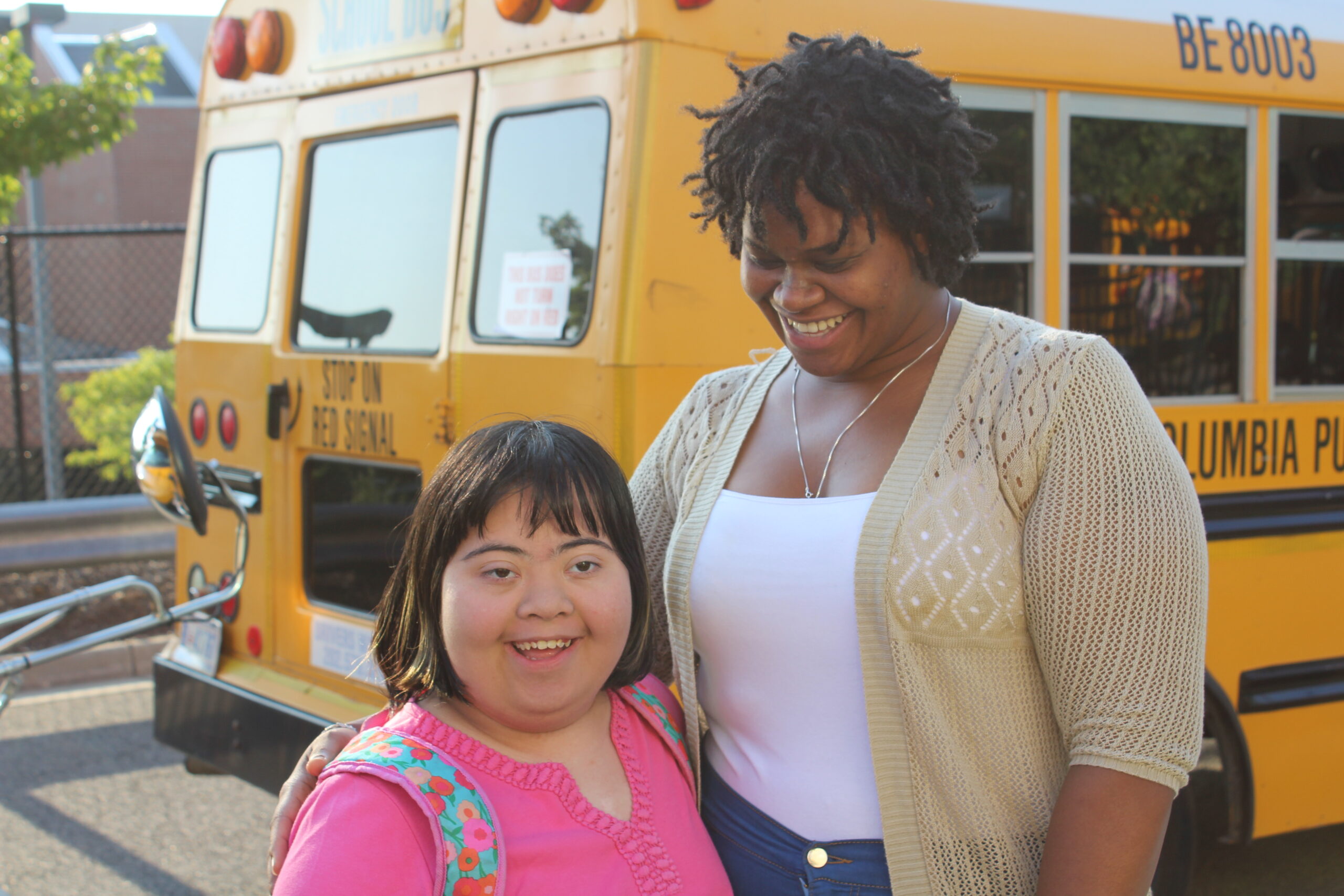 St Coletta student with school staff at bus stop