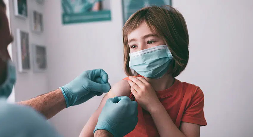 child being prepared for vaccine
