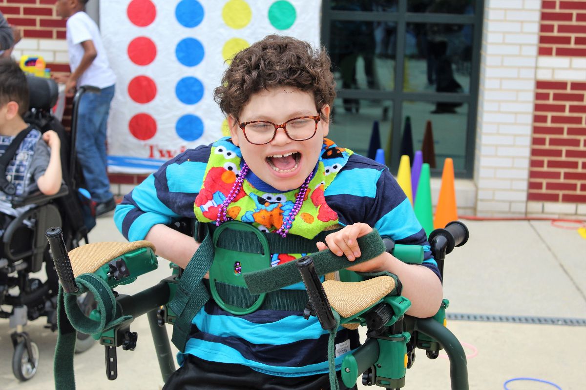 student in a wheelchair on school grounds