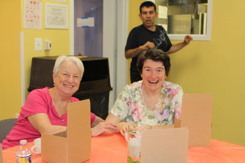 Two adults smiling at the tea party