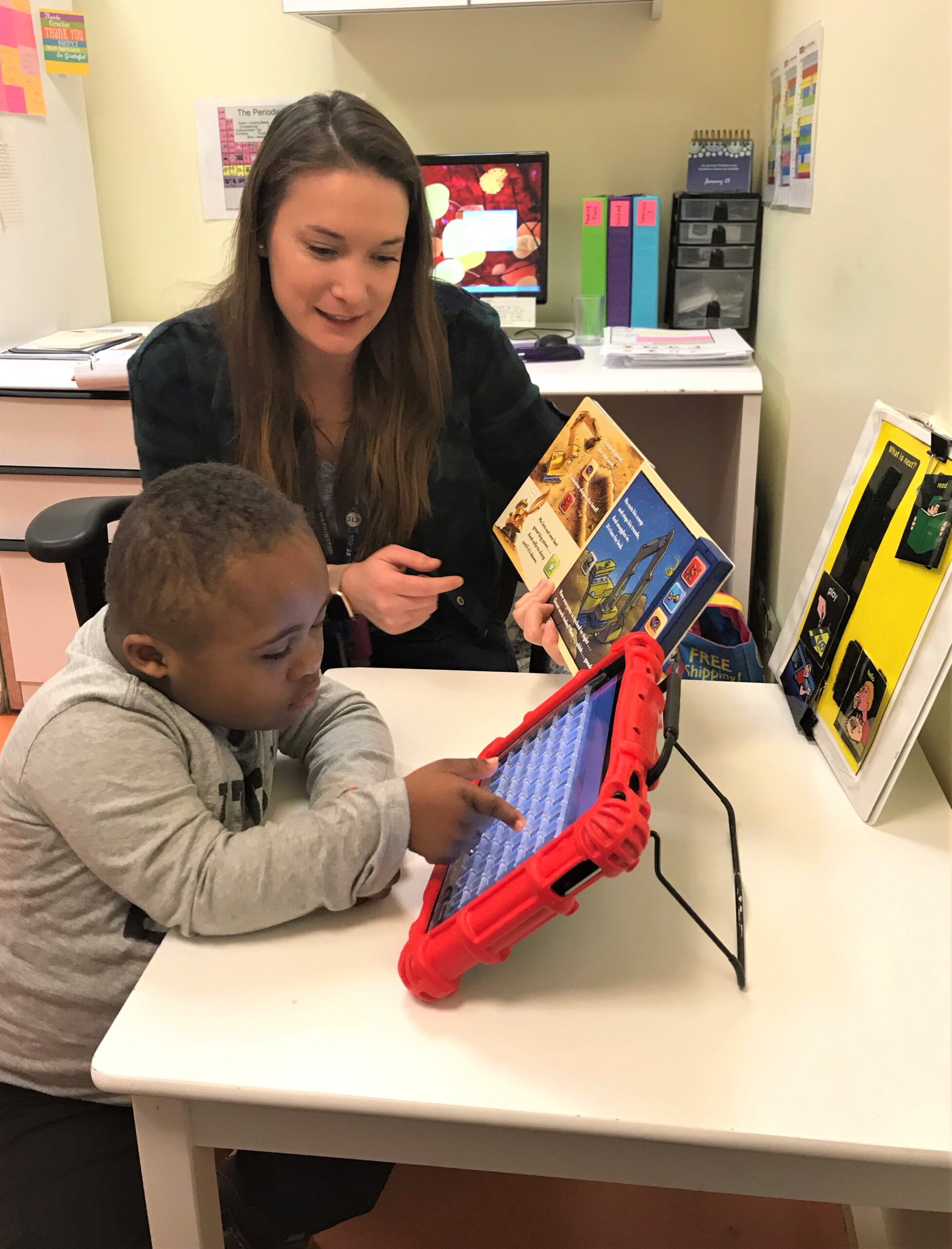 Teacher and young student classroom activity