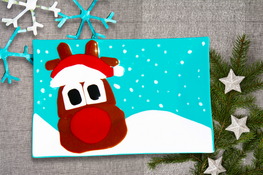 handcrafted fused glass platter with a reindeer and snow background.